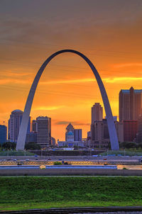 Scenic view of buildings against romantic sky at sunset