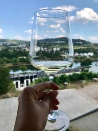 Close-up of hand holding glass of wine