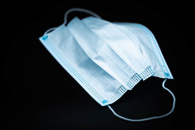 High angle view of blue paper on table against black background