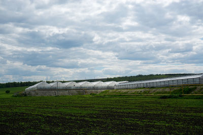 Greenhouses against a cloudy sky