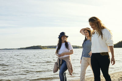 Female friends walking at sea