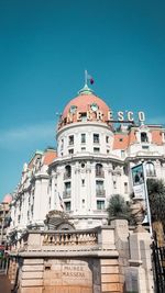 Low angle view of buildings against blue sky