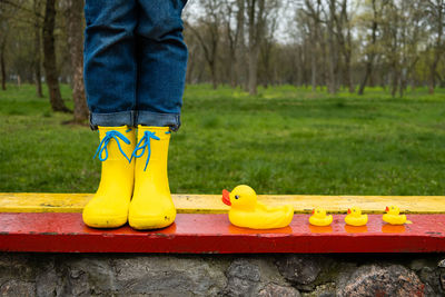 Stress resilience and mental health, no depression concept. womens legs in yellow rubber boots and