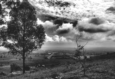 Scenic view of field against cloudy sky