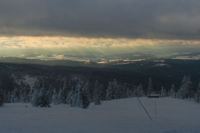 Scenic view of snowcapped mountains against sky during sunset