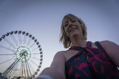 Low angle view of woman against clear sky
