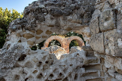 Low angle view of old stone wall