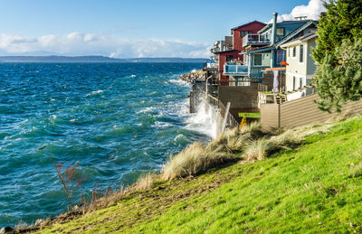Waves on a windy day hit the shoreline near waterfront homes in west seattle, washington.