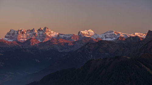 Scenic view of mountains against sky at sunset