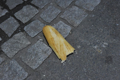 High angle view of yellow leaf on sidewalk