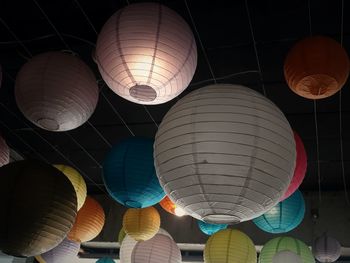 Low angle view of illuminated lanterns hanging at night