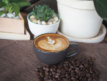 Coffee cup and cookies on table