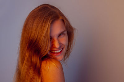 Portrait of young woman against white background