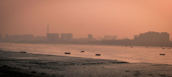 Scenic view of buildings against sky during sunset