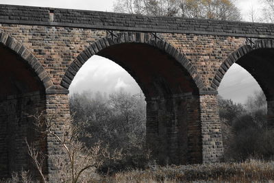 Low angle view of arch bridge against sky