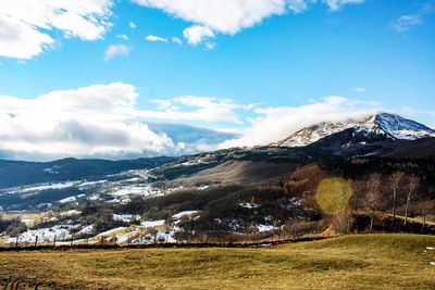 Scenic view of landscape against sky during winter