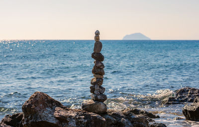 Stacked stones to the tower built on the beach of kos greece