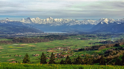 Scenic view of lake and mountains against sky