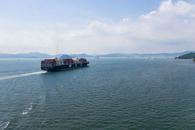 Ship sailing in sea against sky