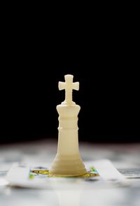 Close-up of chess piece on playing card