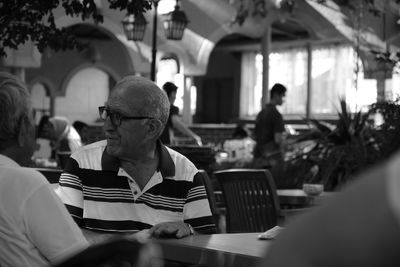 Rear view of man sitting in restaurant