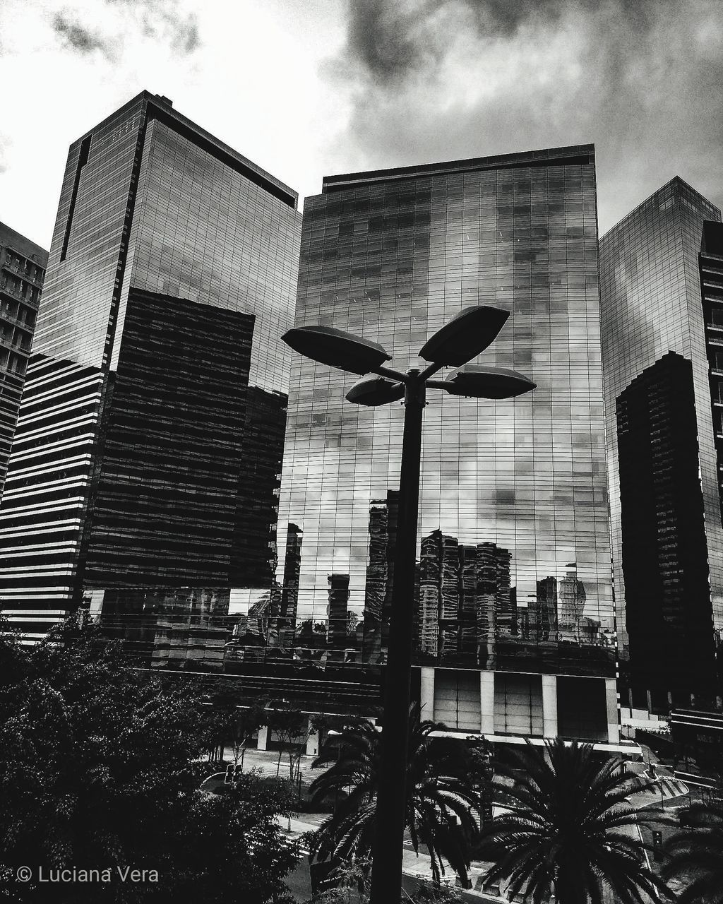 LOW ANGLE VIEW OF MODERN BUILDINGS AGAINST SKY IN CITY