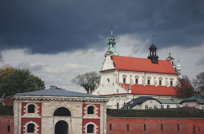 Low angle view of church against cloudy sky