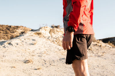 Sport watch detail of anonymous mature sportsman getting ready to run