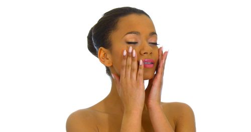 Portrait of shirtless young woman against white background