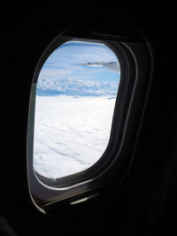 Scenic view of mountains against cloudy sky