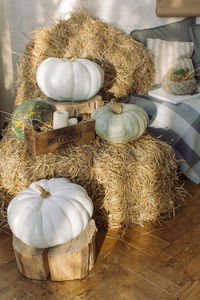 High angle view of pumpkins and hay at home