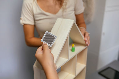 Midsection of woman using digital tablet