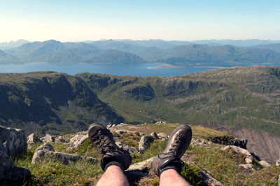 Low section of man against mountains at scottish highlands