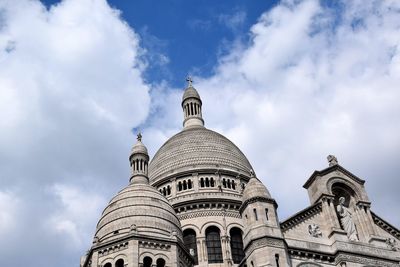 Low angle view of cathedral against cloudy sky