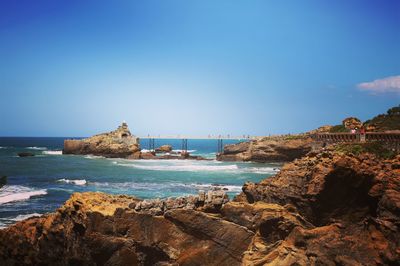 Scenic view of sea against clear blue sky