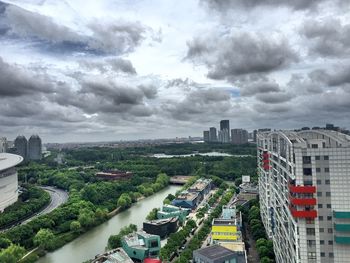 Cityscape against cloudy sky