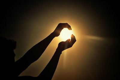 Close-up of hands pretending to hold sun