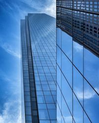 Low angle view of modern building against cloudy sky