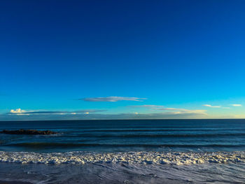 Scenic view of sea against blue sky
