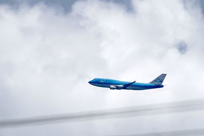 Close-up of airplane against blue sky