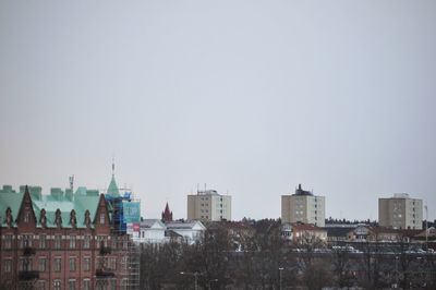 Buildings in city against clear sky