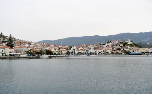 Town by sea against clear sky