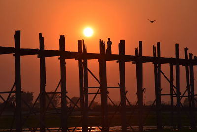 Silhouette birds against sky during sunset