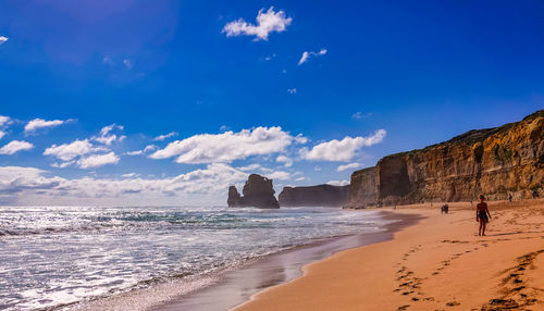 Scenic view of beach against blue sky