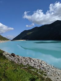 Scenic view of lake and mountains against sky