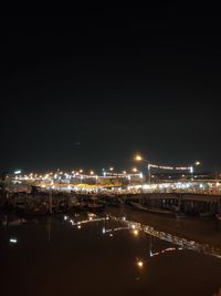 High angle view of illuminated buildings against sky at night