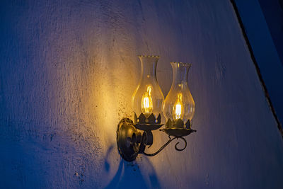 Illuminated light bulb on wall