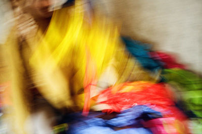 Close-up of person holding multi colored blurred background