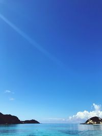 Scenic view of sea against blue sky