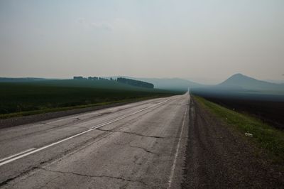 Empty road against sky